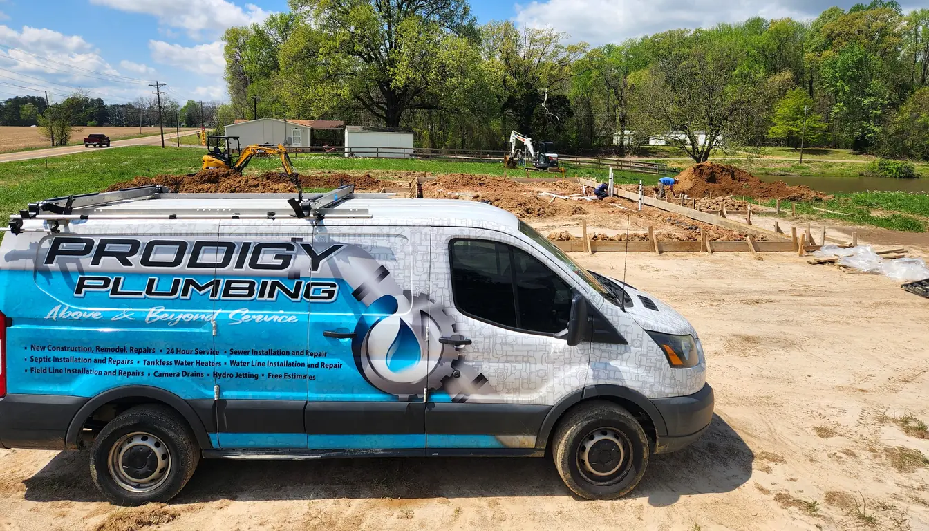 Prodigy Plumbing service van at a new-construction job site